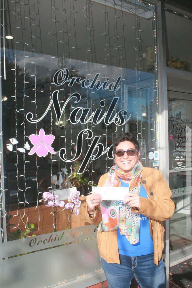 Maria Casini with a gift certificate for Orchid Nails and Spa. Gift certificates, she said, are big items for the holidays.